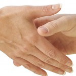 Image to two hands about to grasp in a handshake.